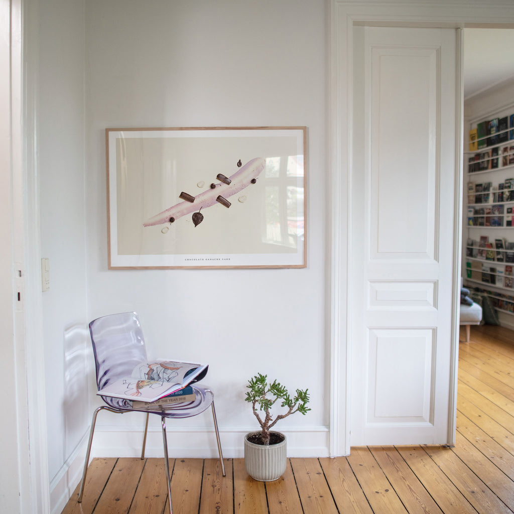 Chocolate Ganache Cake art print in dining room with chair and plant