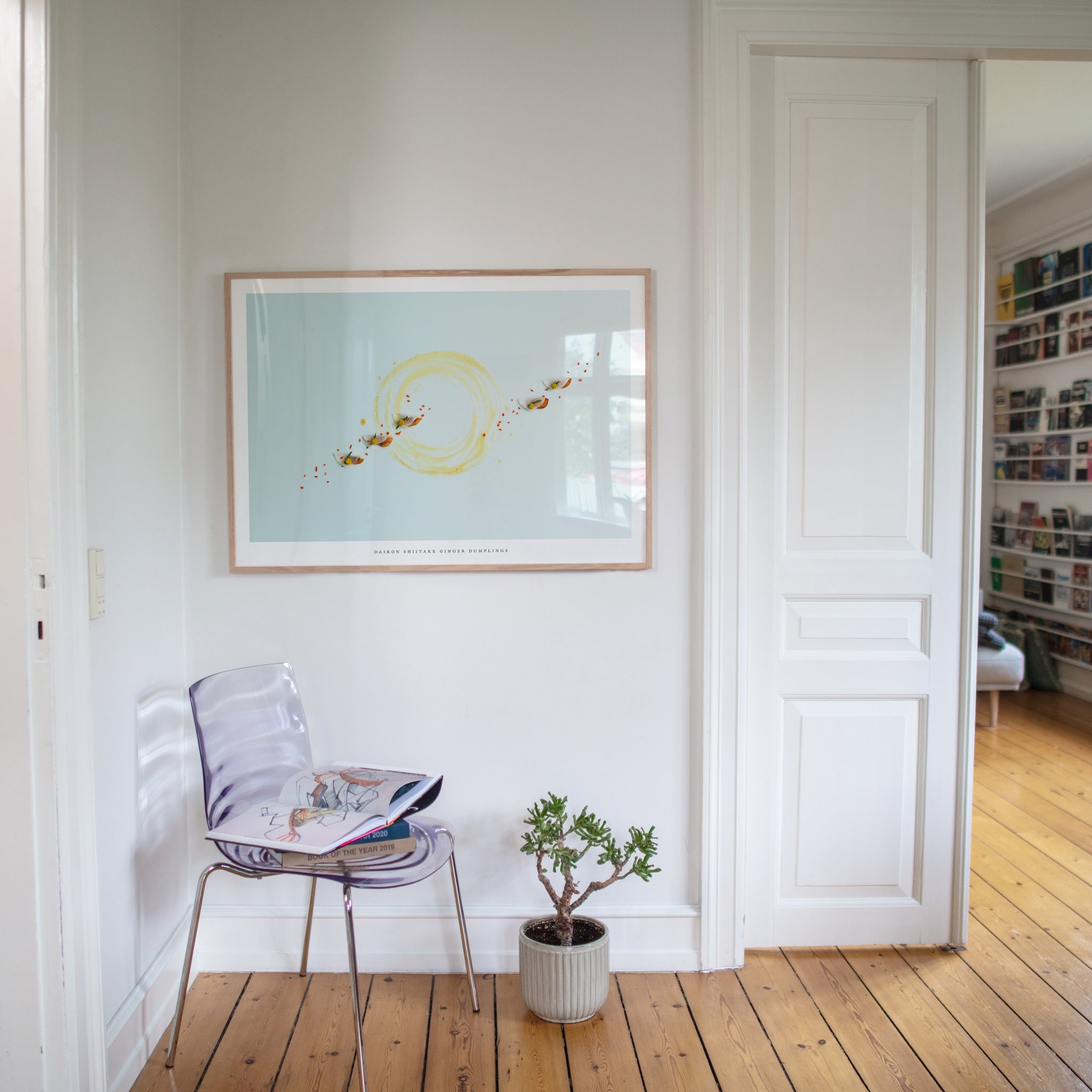Daikon Shiitake Ginger Dumplings poster on white wall with chair and plant