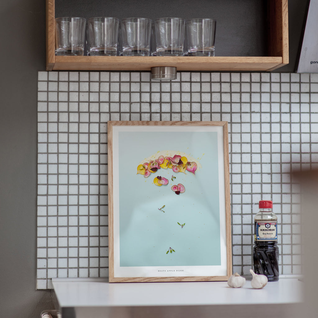 Beets Apple Dijon art print in a kitchen on a tiled wall with a shelf above
