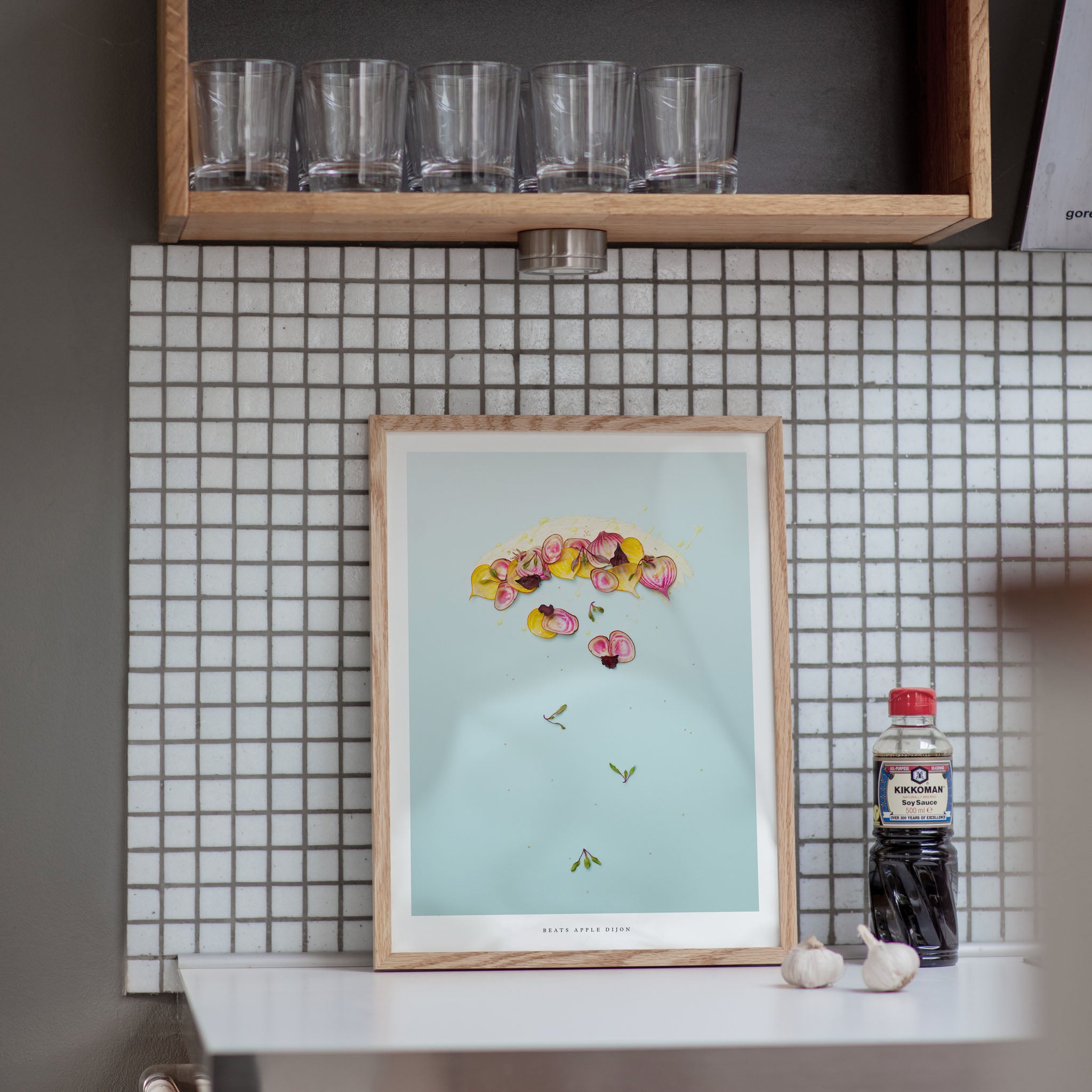 Beets Apple Dijon art print in a kitchen on a tiled wall with a shelf above