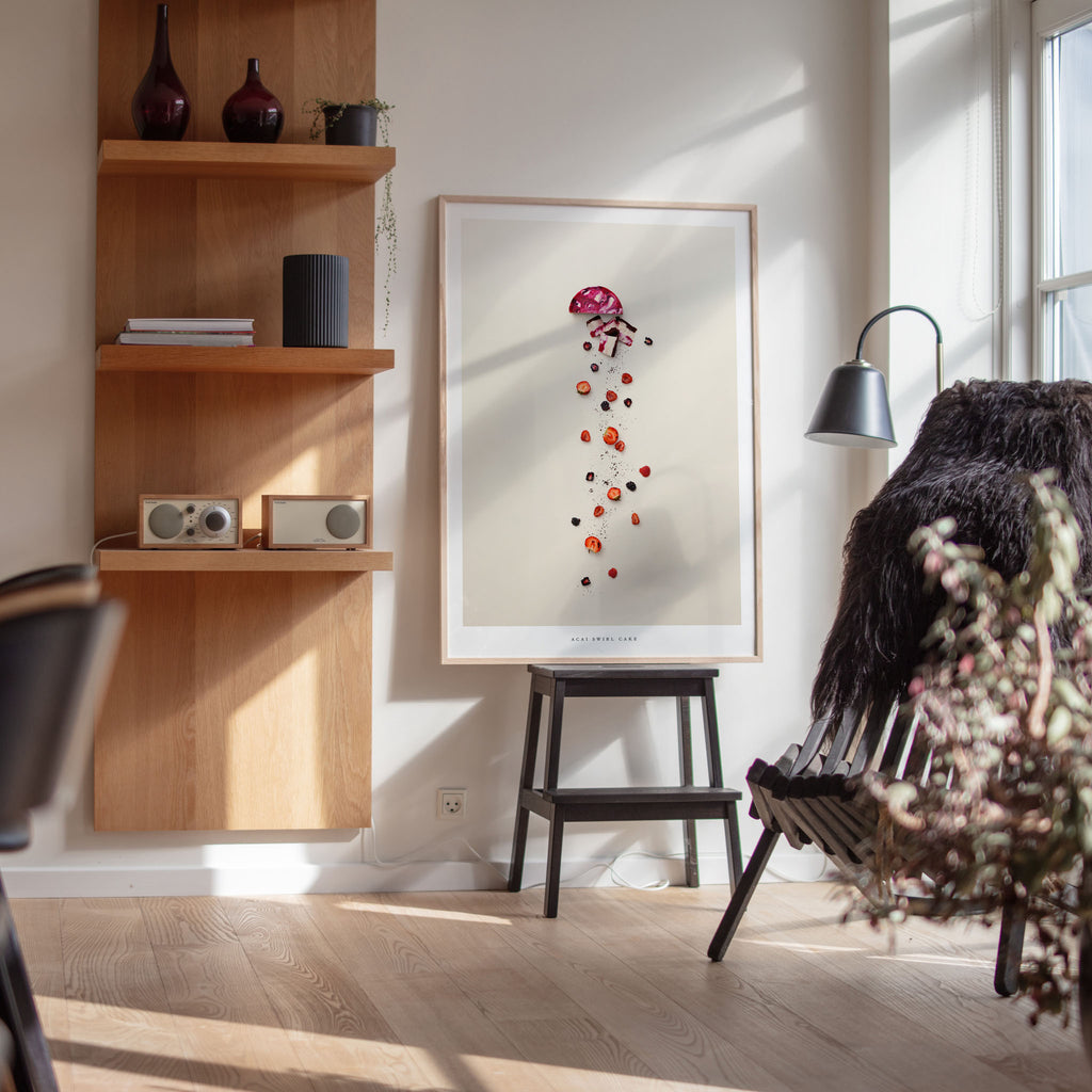 Acai Swirl Cake art print displayed with wooden shelves and chair