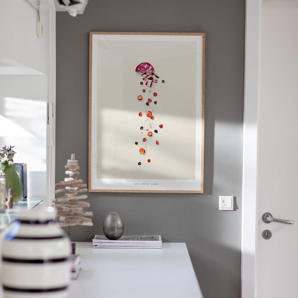 Acai Swirl Cake poster on gray wall with decorative items