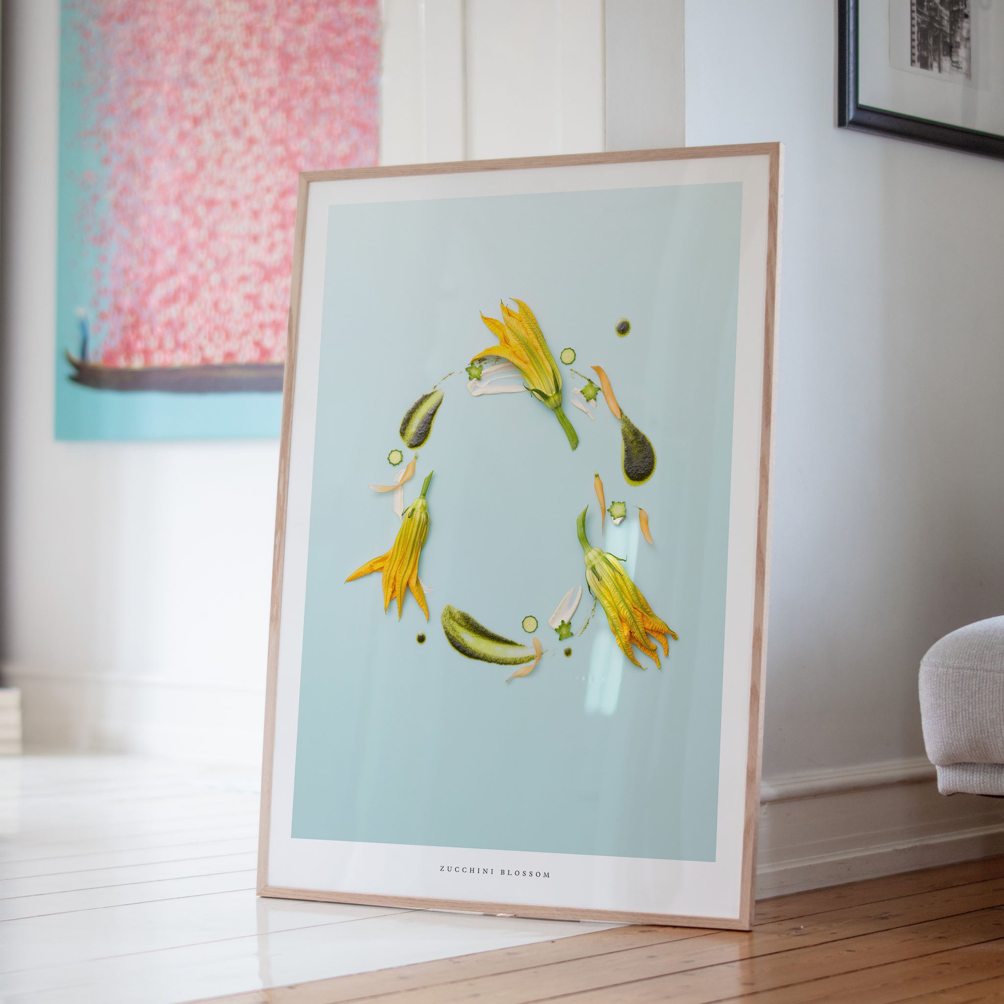 Zucchini Blossom art poster on a light blue background in a room.